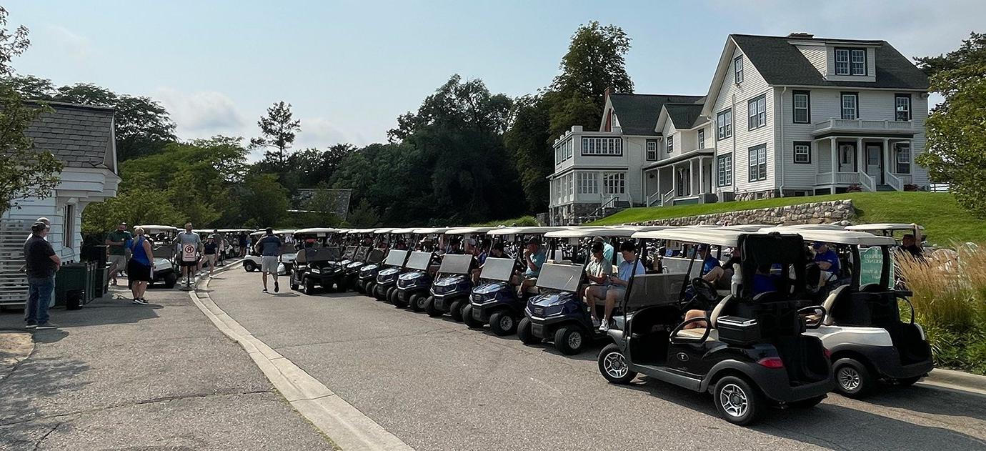 A row of golf carts on the street