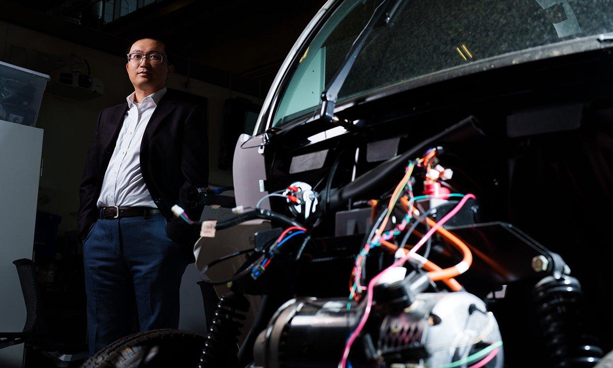 A man standing next to a self-driving car